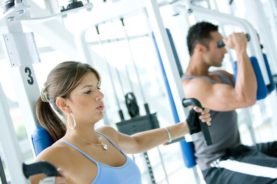 man and woman doing exercises in the gym